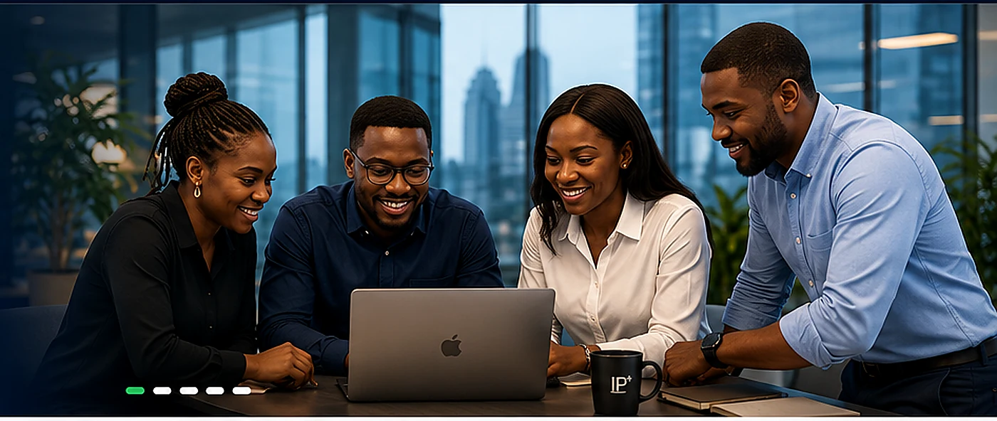 Technology product team collaborating around a laptop in a modern workspace